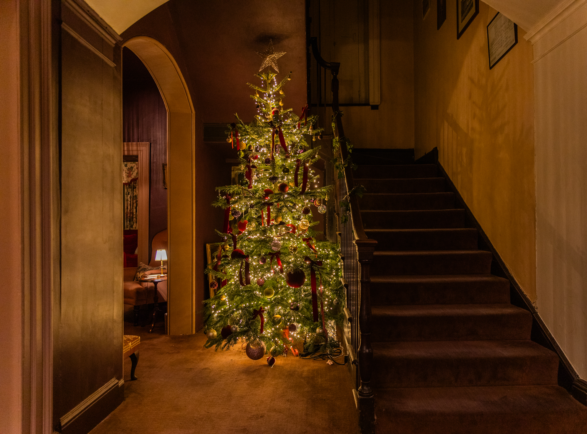 Christmas tree standing beside the Georgian staircase