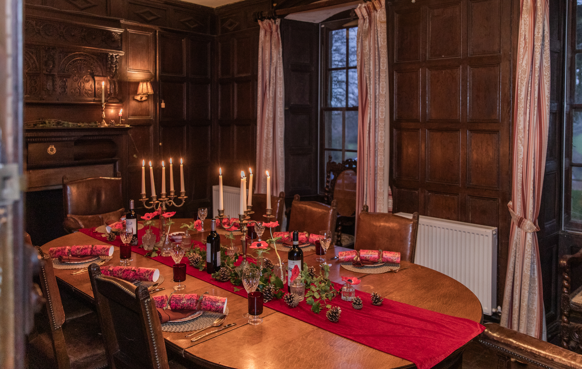 Festive dining table set by candlelight for a Christmas gathering