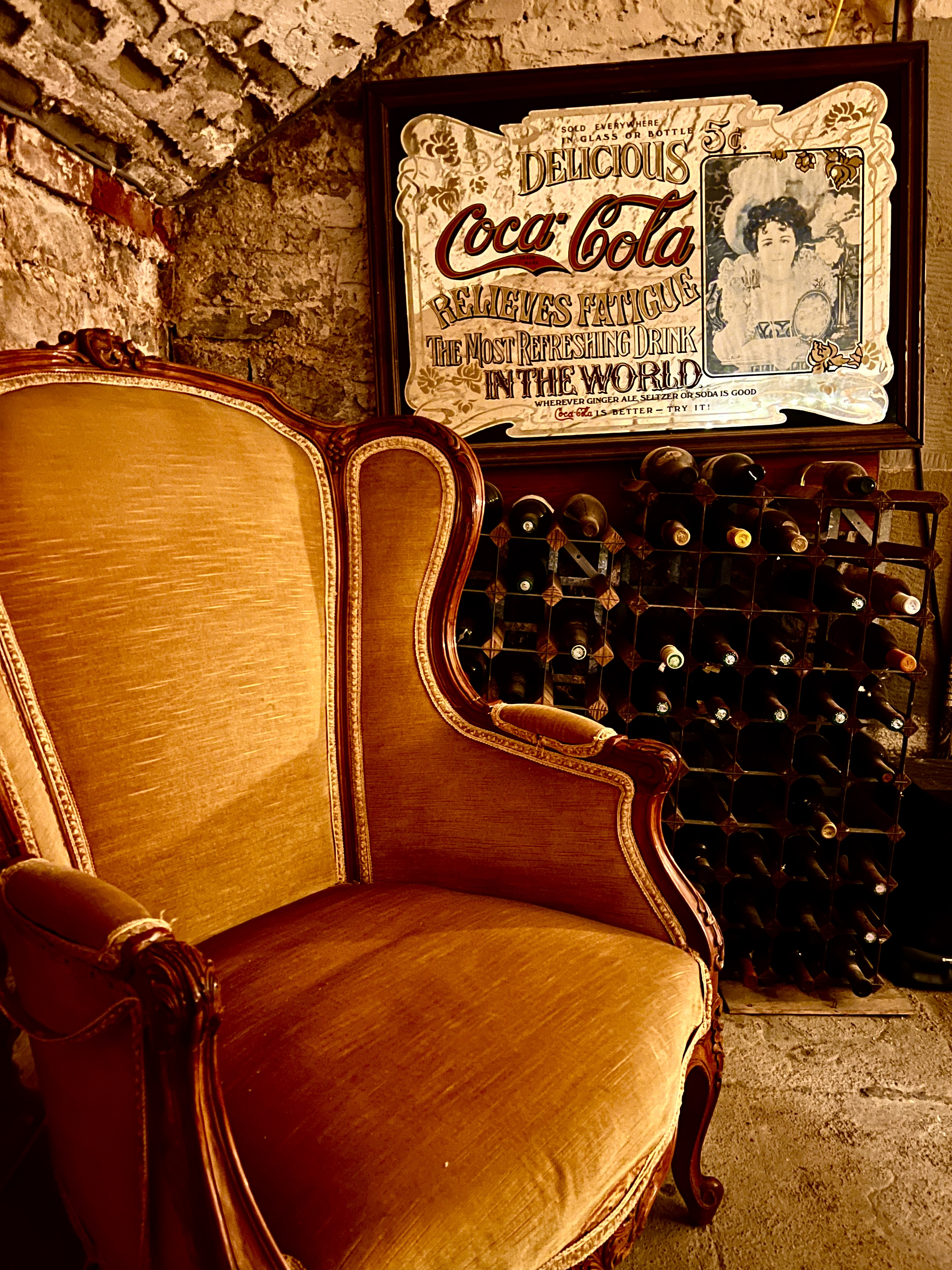 Vintage armchair and wine rack in Montgomery Manor cellar bar