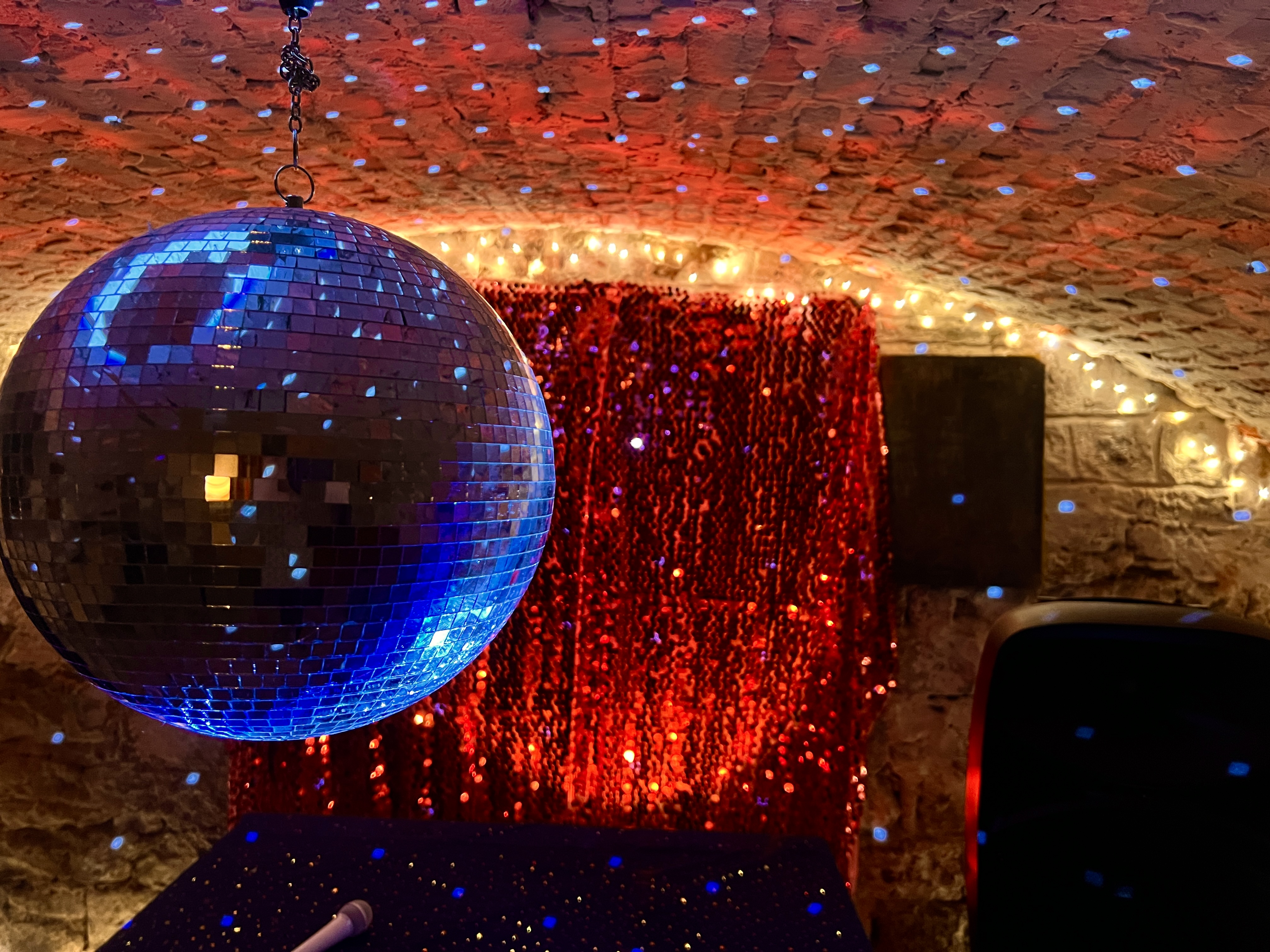 Glitterball and disco lights in Montgomery Manor cellar nightclub