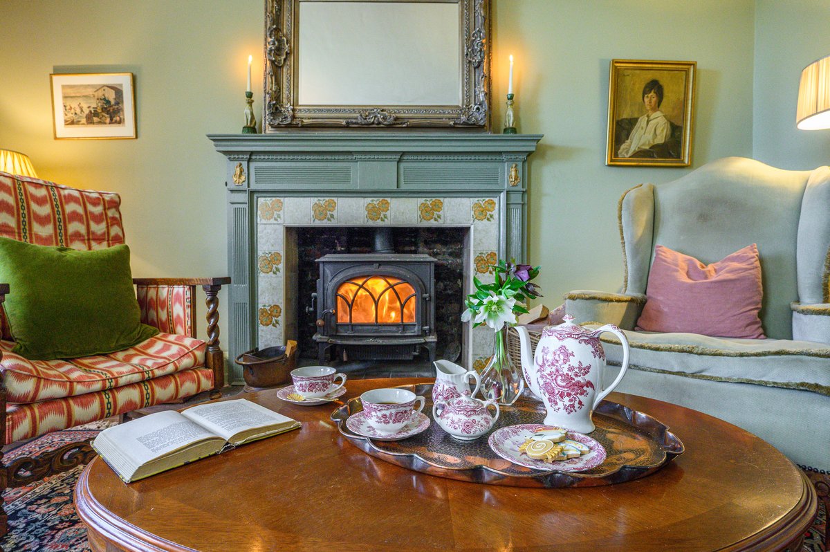 Sitting room with open fire in luxury rural escape
