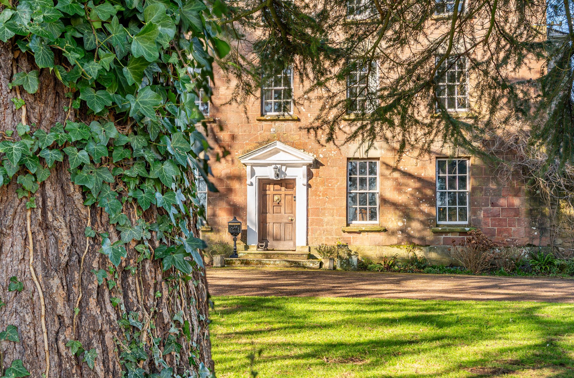 Luxury Georgian manor house exterior in Forest of Dean with stonework and ivy