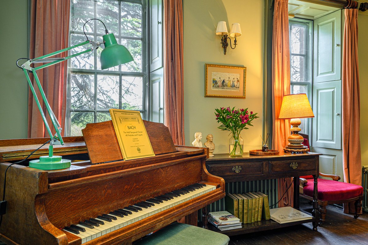 Baby grand piano in morning lounge of luxury manor stay